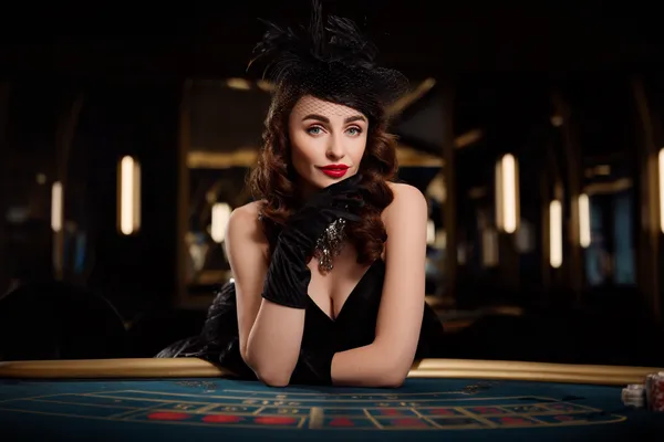 A glamorous woman holding casino chips in a neon-lit environment, representing the premium online casino atmosphere of GT998.